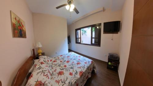 a bedroom with a bed and a window at Casa Centro de Guararema - Casa Bela Vista in Guararema