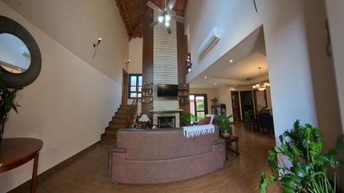 a living room with a large couch and a staircase at Casa Centro de Guararema - Casa Bela Vista in Guararema