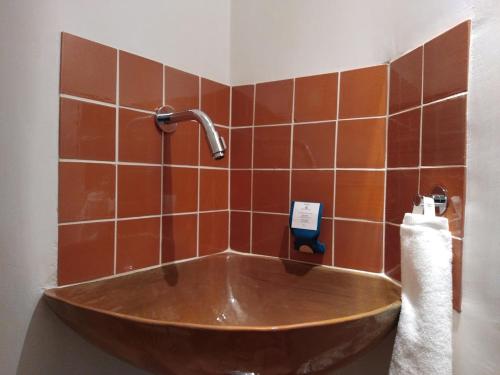a wooden tub in a bathroom with a faucet at Maison La Petite Cour - Spa in Visan