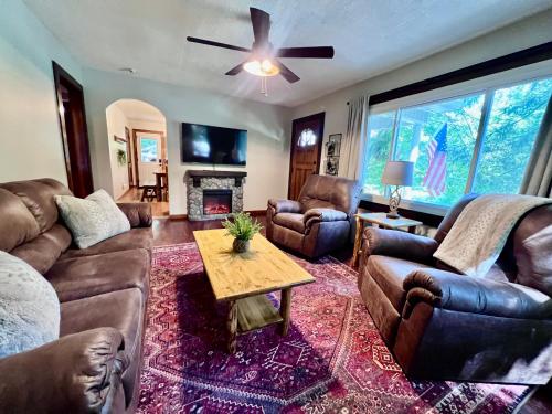 a living room with leather furniture and a fireplace at Mill Haus in South Bloomingville