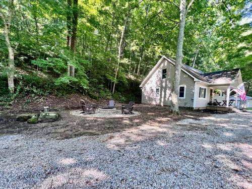 a small house with a fire pit in the yard at Mill Haus in South Bloomingville