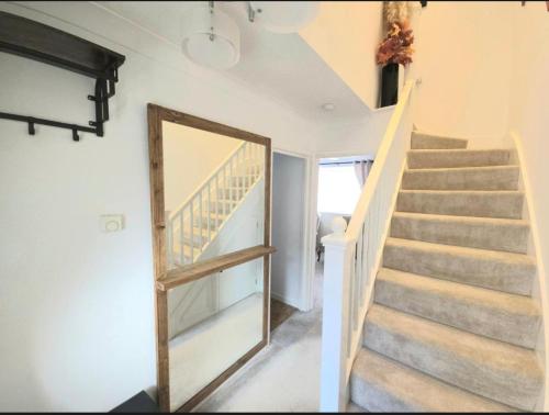a staircase in a house with a mirror at The Serenity Nook - 2 bed flat in the heart of Shefford with parking in Shefford