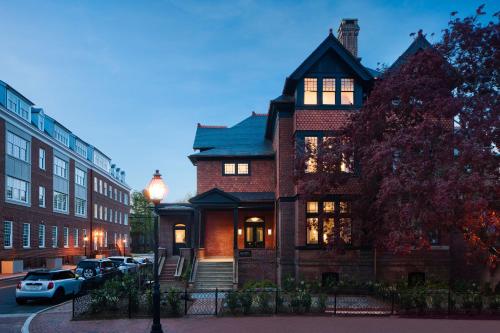 a house on a street with cars parked in front of it at 86 State Circle - Luxury Boutique Hotel in Annapolis