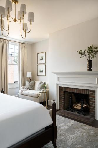 a bedroom with a bed and a fireplace at 86 State Circle - Luxury Boutique Hotel in Annapolis