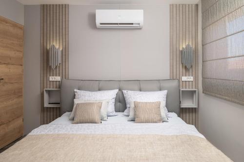 a bedroom with a large bed with white sheets and pillows at Apartment Adela in Vir