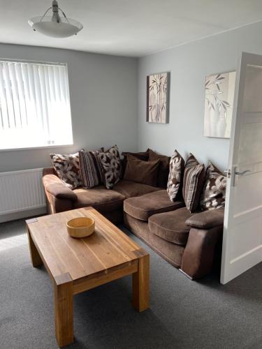 a living room with a couch and a coffee table at Sheffield spa view 2 bed house free parking in Sheffield