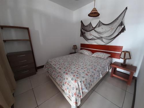 a bedroom with a bed and a dresser and a mirror at Maria Jose Bungalows in Zorritos