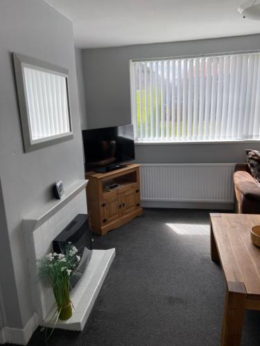 a living room with a couch and a table at Sheffield spa view 2 bed house free parking in Sheffield