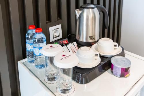 a table with bottles of water and dishes on it at Ivy Garden Hotel Baku in Baku