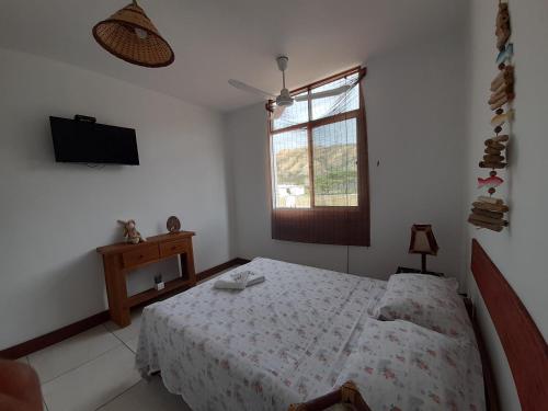 a white bedroom with a bed and a window at Maria Jose Bungalows in Zorritos
