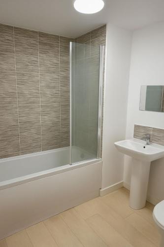 a bathroom with a shower and a sink at Lovely furnished room for stay in Belvedere