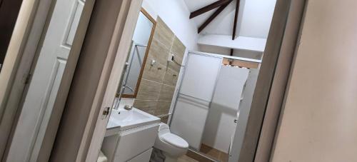 a bathroom with a white toilet and a sink at Casa Santa Rosilla in Lamas