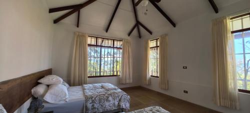 a bedroom with two beds and windows at Casa Santa Rosilla in Lamas