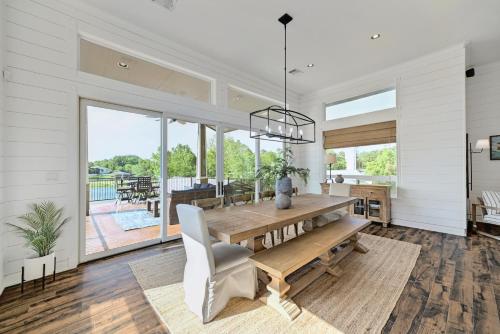 a dining room with a wooden table and white walls at Paradise Cove in Granite Shoals