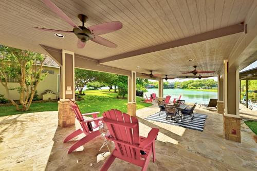a patio with red chairs and a ceiling fan at Paradise Cove in Granite Shoals