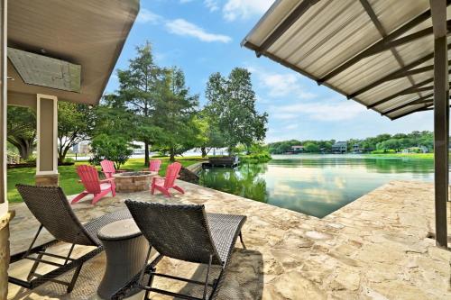 a patio with chairs and a table next to a lake at Paradise Cove in Granite Shoals