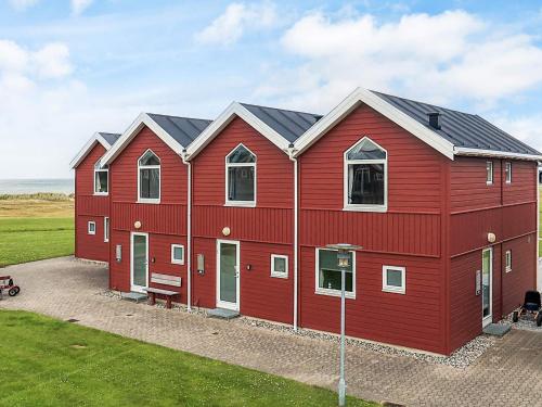 a red house with a red roof at 6 person holiday home in Hadsund-By Traum in Hadsund