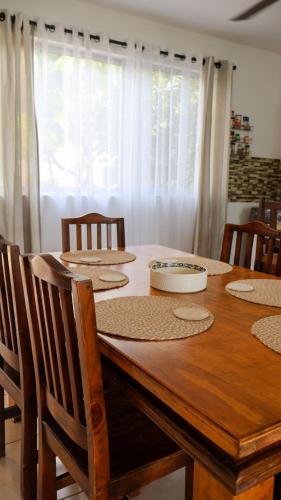a dining room table with chairs and a wooden tableablish at Casa Brisa with a private pool in Bejuco in Bejuco