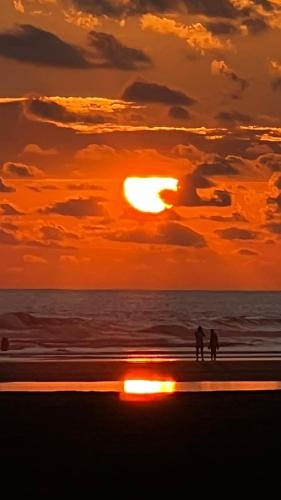 two people walking on the beach at sunset at Casa Brisa with a private pool in Bejuco in Bejuco
