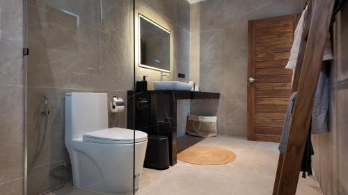 a bathroom with a toilet and a sink at ILKI 2BR Pool Villa in Ko Phangan