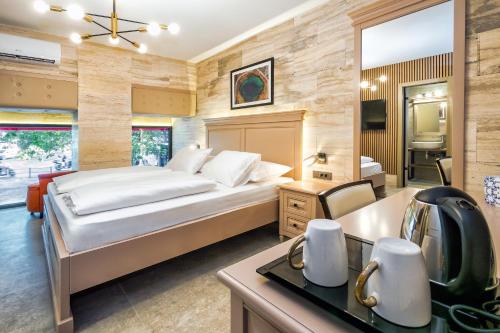 a bedroom with a large bed and a bathroom at Central Pazar Rooms in Split