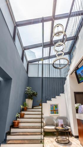 a staircase with a glass ceiling and a chandelier at Ivy Garden Hotel Baku in Baku