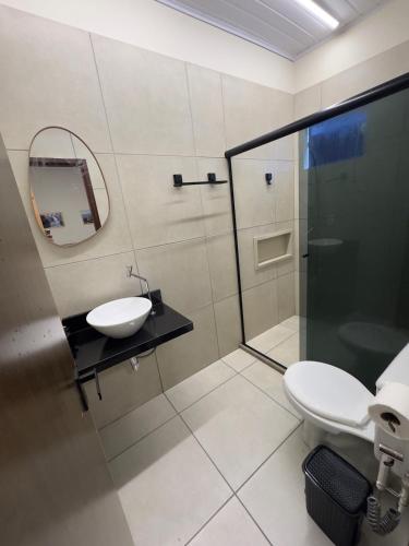 a bathroom with a toilet and a sink and a shower at Flat 02 - Novo e completo em Bonito, Pernambuco in Bonito
