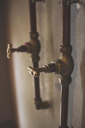 a close up of two water faucets on a wall at A Hilltop Country Retreat in Swellendam
