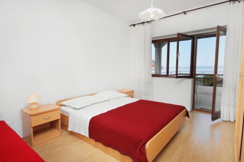 a bedroom with a bed and a view of the ocean at Apartments by the sea Klenovica, Novi Vinodolski - 5581 in Klenovica