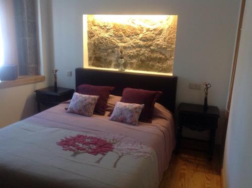 a bedroom with a large bed with a window at Casa da Ponte do Porto in Amares