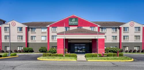 a rendering of a hotel with a red building at Evergreen Inn & Suites in Monroe