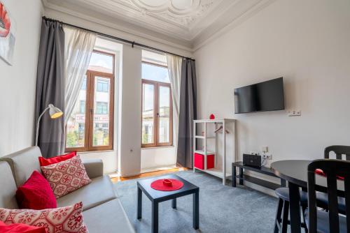 a living room with a couch and a table at Gardenia Urban Retreat in Porto