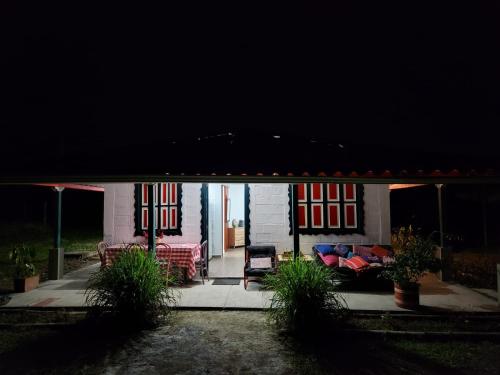a house with a porch with chairs and a couch at Cabaña hospedaje Masinga in La India