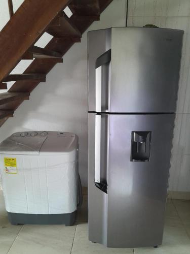 a stainless steel refrigerator next to a trash can at casa xiomy in Capurganá