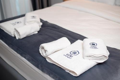 two towels are sitting on a bed at Gori Apartments in Gori