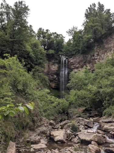 a waterfall on the side of a mountain at Apartament Rodopi in Smolyan