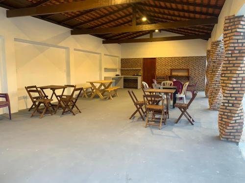 a group of tables and chairs in a room at Chalé Rota Das Dunas in Barreirinhas