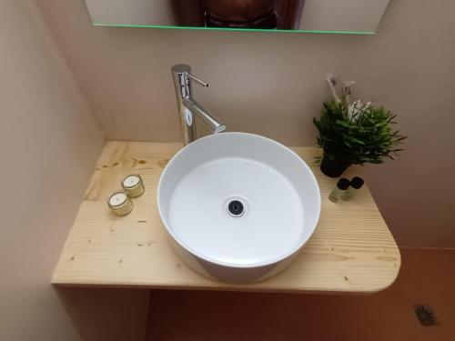 a white sink on a wooden counter in a bathroom at Amazing Experience in Cyclades in Adamas