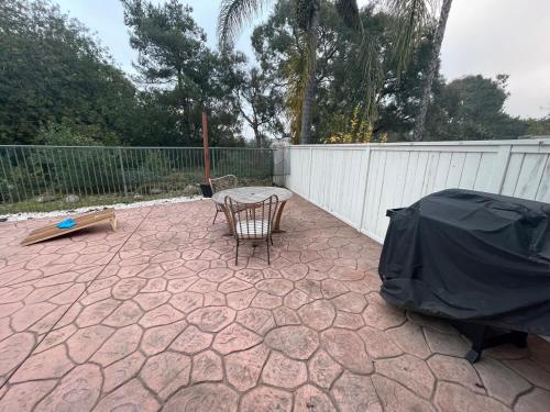 a patio with a chair and a table and a fence at Family-Friendly Sunny SD Escape, Sleeps 8, Beach, Zoo, Downtown & Convention Center in San Diego