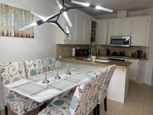 a kitchen with a table with chairs and a ceiling fan at Family-Friendly Sunny SD Escape, Sleeps 8, Beach, Zoo, Downtown & Convention Center in San Diego