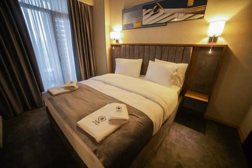 a hotel room with a bed with towels on it at Gori Apartments in Gori