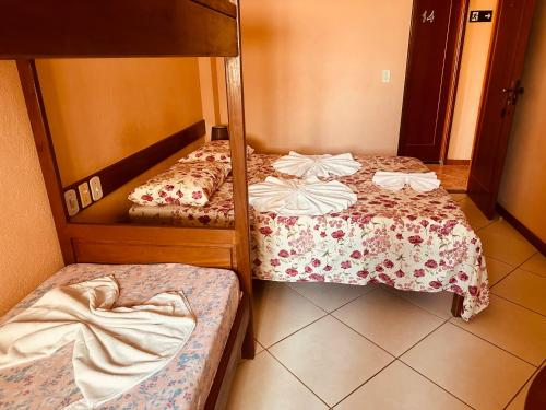 a room with two bunk beds in a room at Pousada Maravista in Anchieta