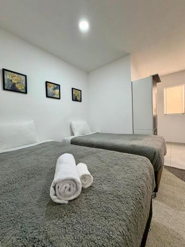 two beds with towels on them in a room at Apartamento Independiente 2 camas individuales in Lima