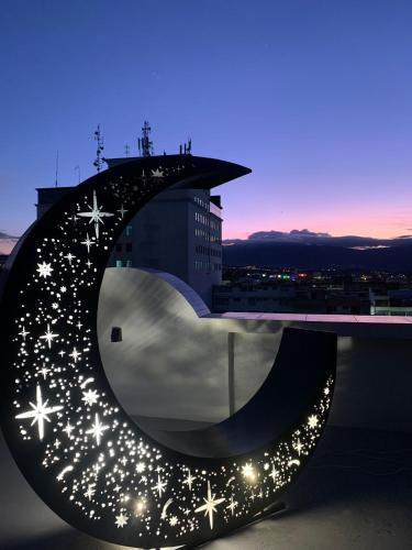 a sculpture of a moon with stars on a building at Royal Ruiz in Ibarra