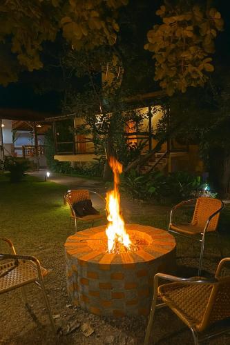 a fire pit in the middle of a yard at night at Pousada Bella Vista in Serra do Cipo