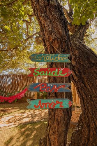a sign attached to a tree with a tree at Pousada Bella Vista in Serra do Cipo