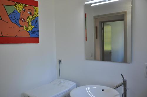 a bathroom with a sink and a mirror at Gîte chez le Gaulois in Carsac-Aillac