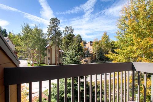 a balcony with a fence and trees and houses at Winter Point 22 in Breckenridge