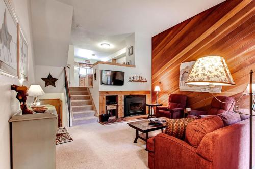 a living room with a couch and a fireplace at Winter Point 22 in Breckenridge