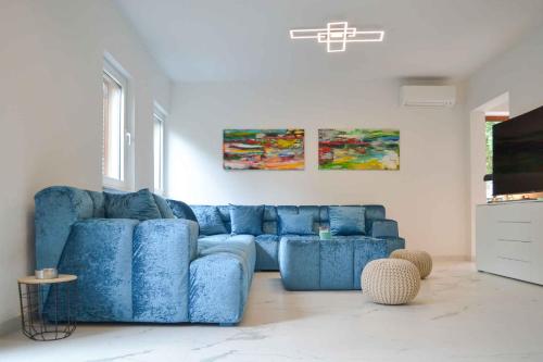 a blue couch sitting in a living room at Holiday home in Punat - Insel Krk 54520 in Punat
